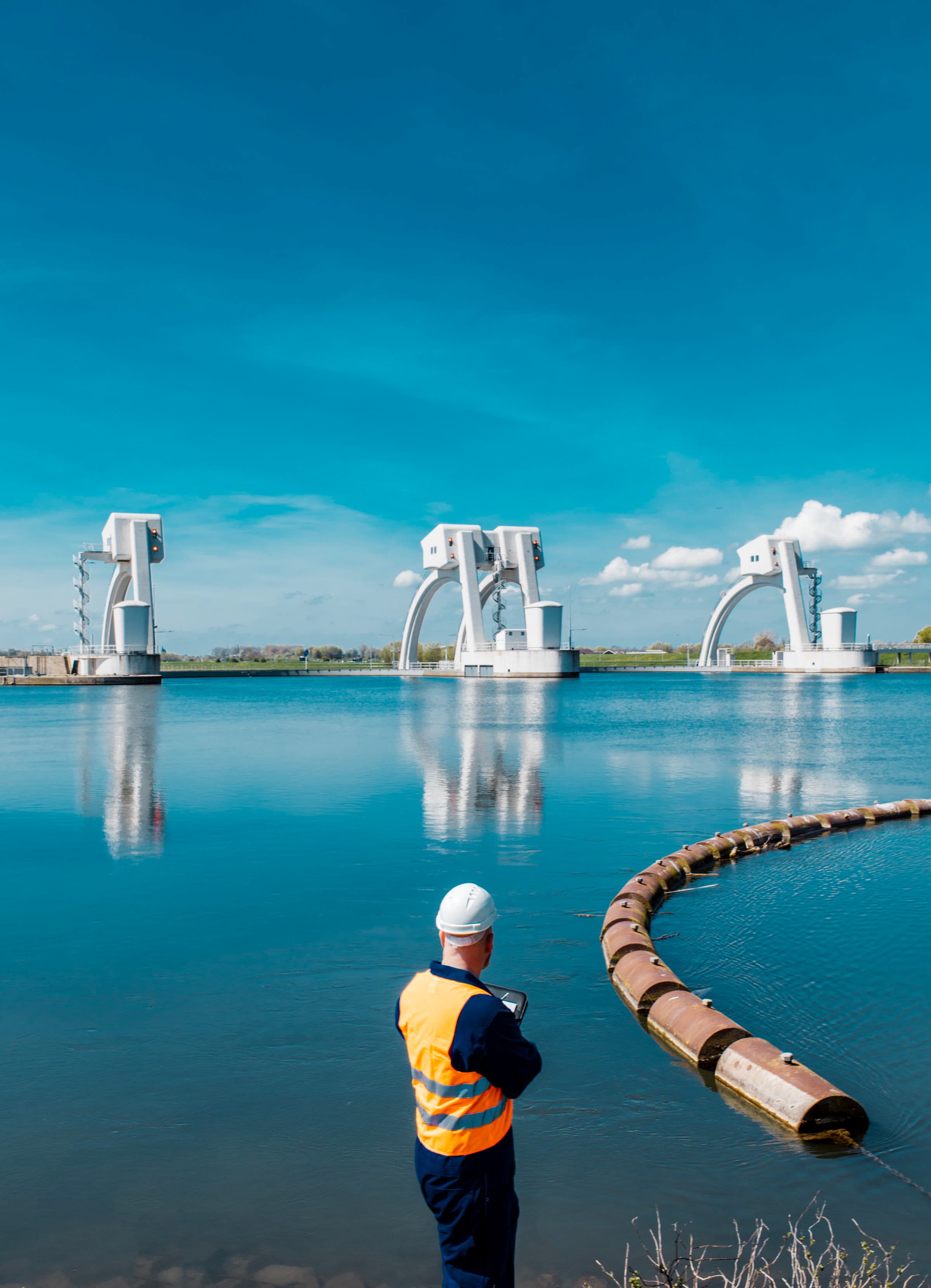 Engineer observing large water-infrastructure flood gates